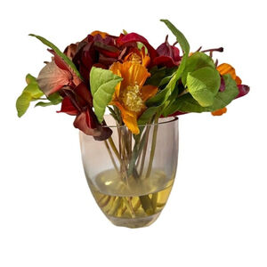 Artificial silk flower arrangement in clear glass vase